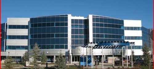 The Smart Executive Centre at 1925 18 Avenue NE, Calgary — a modern four-storey glass office building